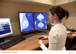 Radiology technician looking at mammography