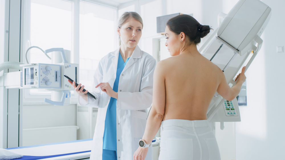 radiologist talking with mammogram patient