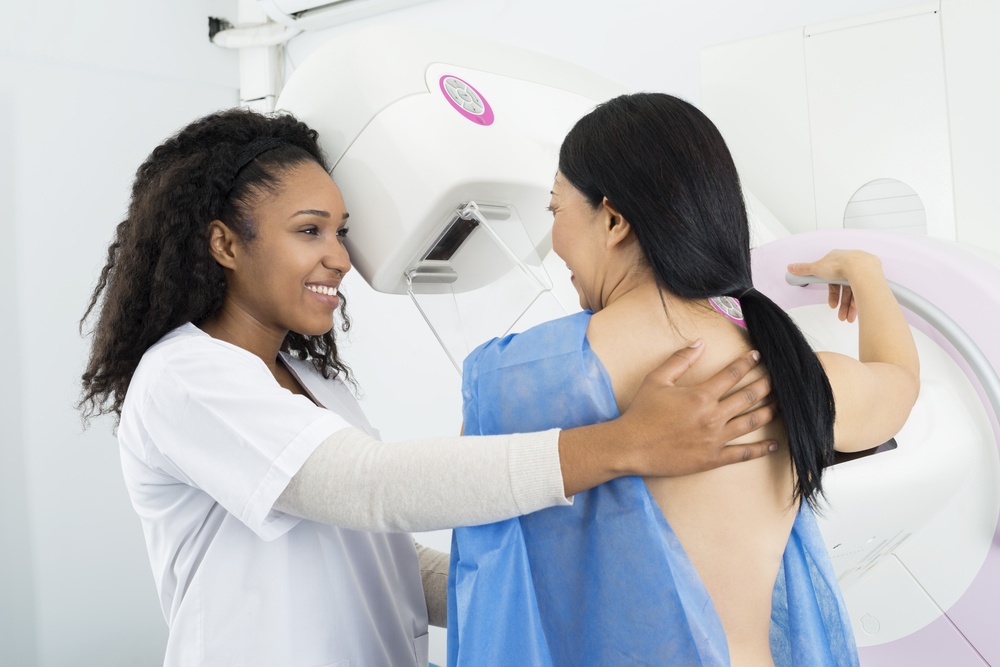 Happy,Doctor,Assisting,Woman,Undergoing,Mammogram,X-ray,Test