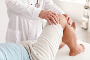 doctor examining patient's knee
