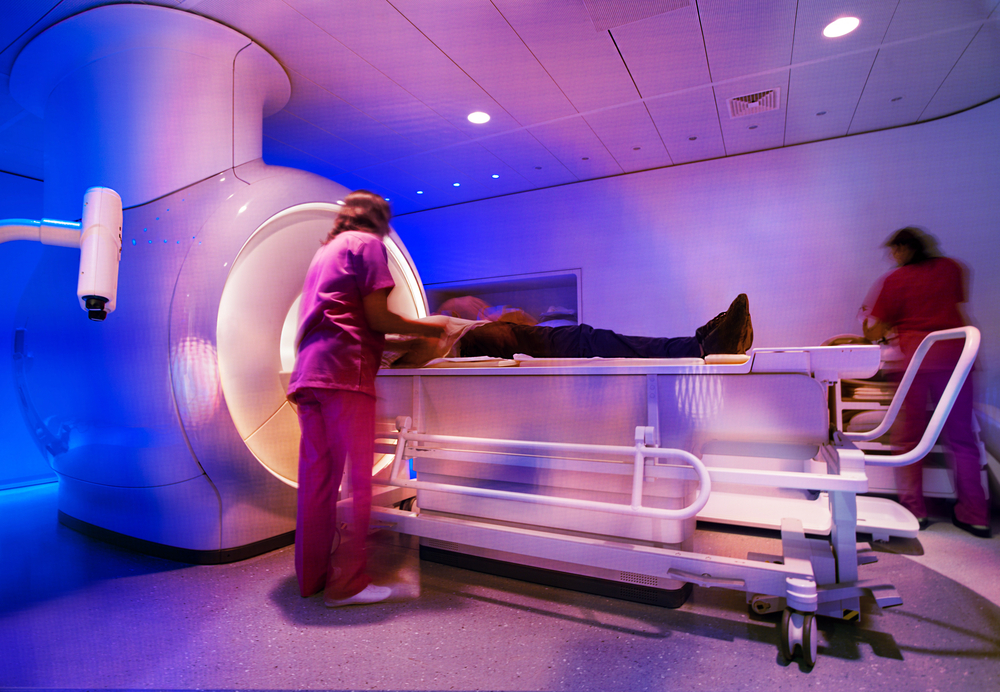 Person laying on MRI machine.