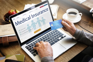 Man looking at medical insurance benefits on computer. 