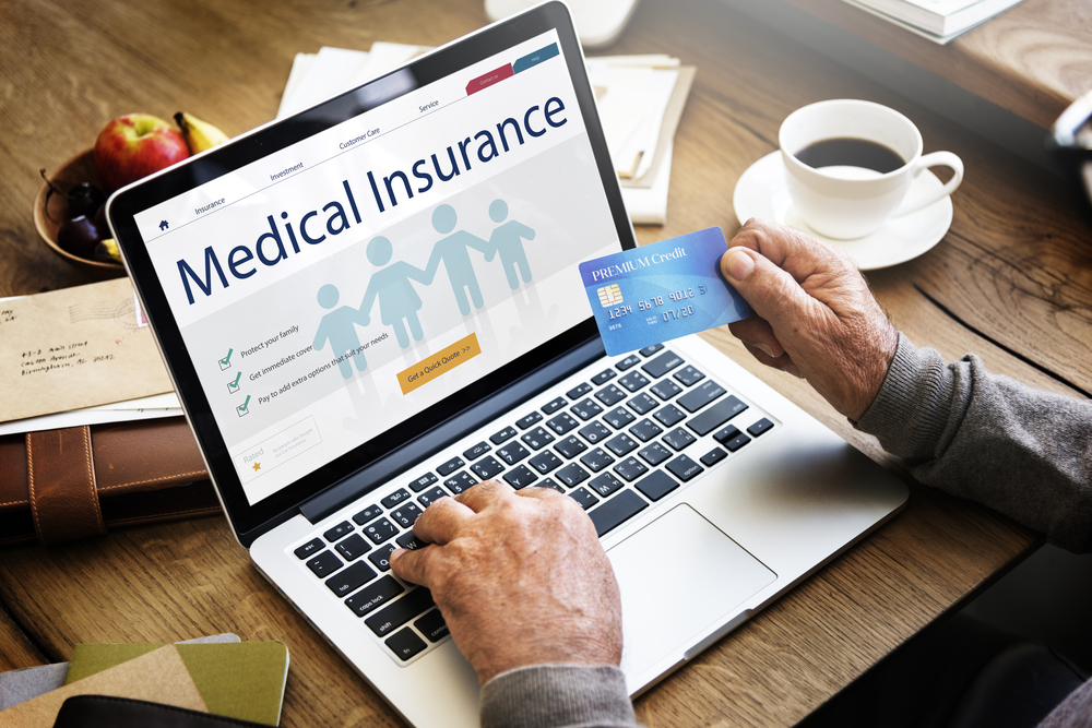 Man looking at medical insurance benefits on computer.
