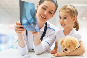 Child looking at xray with doctor.